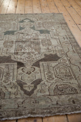 Distressed Hamadan rug pile showcasing shield medallion, boteh motifs, time-softened silver, dusty blue.