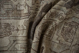 Distressed vintage Hamadan rug with geometric motifs, soft textures, and muted beige, silver, and dusty blue tones.