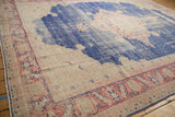 Distressed pale royal blue field with faded blush red patterns and visible wear.