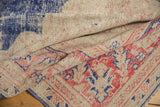 Distressed vintage Oushak pile texture, revealing worn knot heads and faded blue, blush colors.