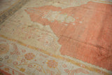 Vintage Oushak carpet's prayer motif, pale tangerine abrashed field, wide ivory patterned border.