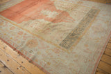 Oushak rug corner with saffron, oxidized silver main border and pale tangerine fringed end.