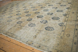 Distressed Sivas carpet detail: faded ivory field with navy trellis and Herati border.
