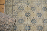 Distressed beige, dusty navy blue trellis pattern, and floral border on Sivas carpet.