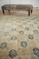 Vintage distressed Sivas carpet field, traditional ivory with dusty navy blue lattice pattern.
