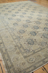 Distressed vintage Sivas carpet detail; ivory field with blue trellis and Herati border.