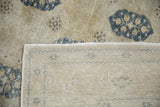 Worn ivory and navy pile texture with the Sivas rug's hand-knotted foundation.