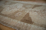Distressed Oushak rug, abrashed beige and brown field with pale blush and ivory pattern.