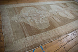 Distressed Oushak carpet edge, showing intact selvage and textural floral border.