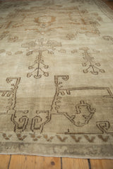 Close-up of vintage distressed Oushak rug with soft pile and stylized botanical motifs.