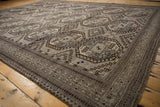 Ersari carpet showcasing geometric guls, diamond patterns, intricate borders, and even wear.