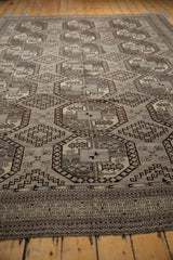 Distressed Ersari carpet: geometric guls, stepped medallions, and border in silver, charcoal, ivory.