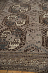 Distressed vintage Ersari carpet with geometric tribal border and textured guls.