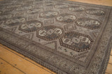Detailed geometric border and distressed field of silver and charcoal Ersari rug.