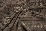 Distressed texture and geometric guls in silver, charcoal, ivory on a vintage Ersari carpet.
