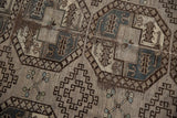 Distressed Ersari carpet showing geometric guls, stepped medallions in silver and charcoal.