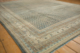 Distressed Mir Sarouk rug corner with faded blue, beige, and brown multi-band borders.