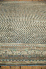 Traditional Persian Mir Sarouk carpet border detail, pale blue animal motifs, and worn diamond field.
