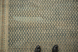 Distressed Mir Sarouk carpet, with faded navy, beige allover boteh pattern.