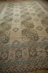 Distressed Ersari carpet border with geometric patterns in ivory, pale brown, and dusty navy.