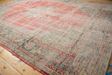 Distressed Oushak carpet corner with worn pale red pile and detailed serrated leaf border.