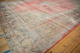 Vintage distressed Oushak rug's vibrant red side cord and worn textural pile.