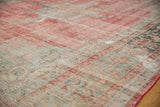 Distressed Oushak carpet texture with exposed foundation, showing pale red and soft grey.
