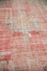 Distressed pile texture on vintage Oushak rug with pale red and oxidized silver tones.
