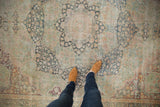 Antique Distressed Kerman carpet underfoot, revealing low pile and faded millefleur floral motifs in soft tones.