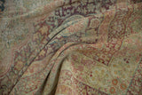 Textured pile of a distressed antique Kerman carpet, with faded millefleur design in muted red and teal.