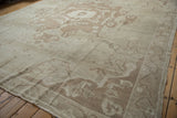 Distressed Oushak rug detail: ivory field with pale coffee brown germinating tendrils, mostly even wear.