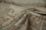 Distressed Oushak rug pile shows subtle ivory, pale coffee brown, and beige curvilinear patterns.