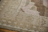 Distressed vintage Oushak rug detail: soft beige, pale pink, and mostly even pile wear.