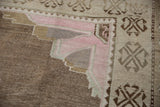 Distressed vintage Oushak carpet corner with pink spandrel and expressive textural abrashes.