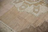 Vintage Distressed Oushak rug pile showing neutral geometric patterns, soft pink, and abrash.