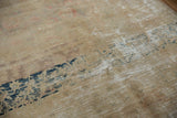 Textured distressed Kashan rug, worn beige pile revealing foundation and subtle navy motif.