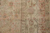 Distressed Khotan carpet detail showing wear to pile, exposed foundation, and floral motifs.