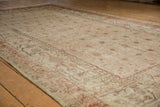 Vintage distressed Uzbeki Khotan rug, faded beige, terracotta floral lattice, worn pile.