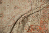 Worn pile texture of distressed Khotan carpet, showing foundation in beige and burnt orange.