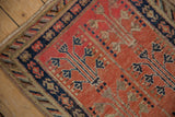 Hand-knotted vintage Khotan runner corner: navy crab border, red geometric field.