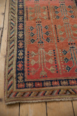 Corner detail of Vintage Khotan runner, showing fringe, intact side selvage, and navy crab border.