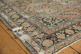 Distressed navy border with floral motifs and worn dusty rose field on Dargezine carpet.