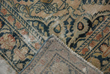 Distressed vintage Persian Dargezine carpet corner, showing worn floral motifs, foundation, and selvage.