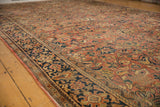 Vintage Mahal carpet's navy border and muted brick red field with expressive floral motifs.