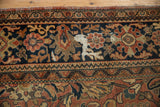 Vintage Mahal carpet: intricate borders frame floral arabesque on navy, brick red, and gold field.