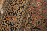 Hand-knotted vintage Mahal carpet section, showing expressive floral arabesque in navy and brick red.