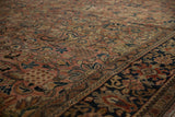 Brick red field with expressive floral arabesque meeting a navy patterned border.