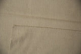 Ivory flat woven texture of the vintage Turkish rug, showcasing hand-spun weave.