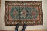 Lower end of vintage Turkish flatweave carpet, showing teal field and patterned borders.
