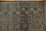 Distressed vintage Ersari corner showing geometric borders and gul motif texture.